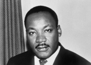 a black and white photo of a man in a suit