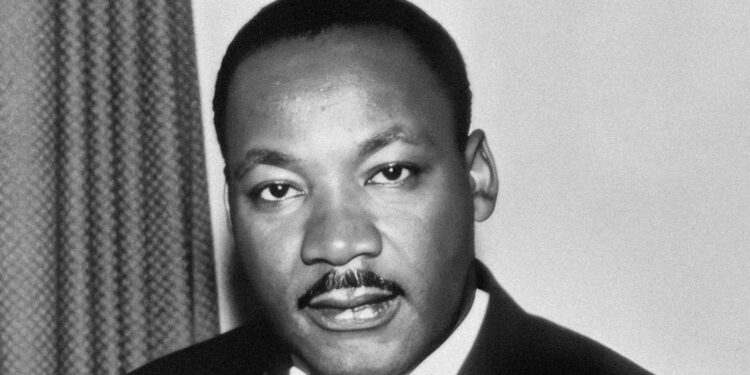 a black and white photo of a man in a suit
